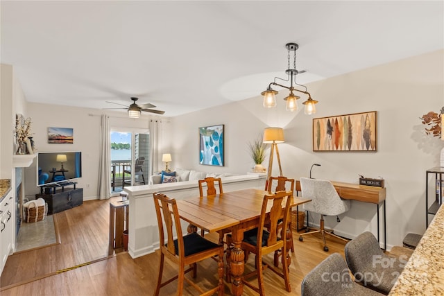 dining space with ceiling fan and wood-type flooring