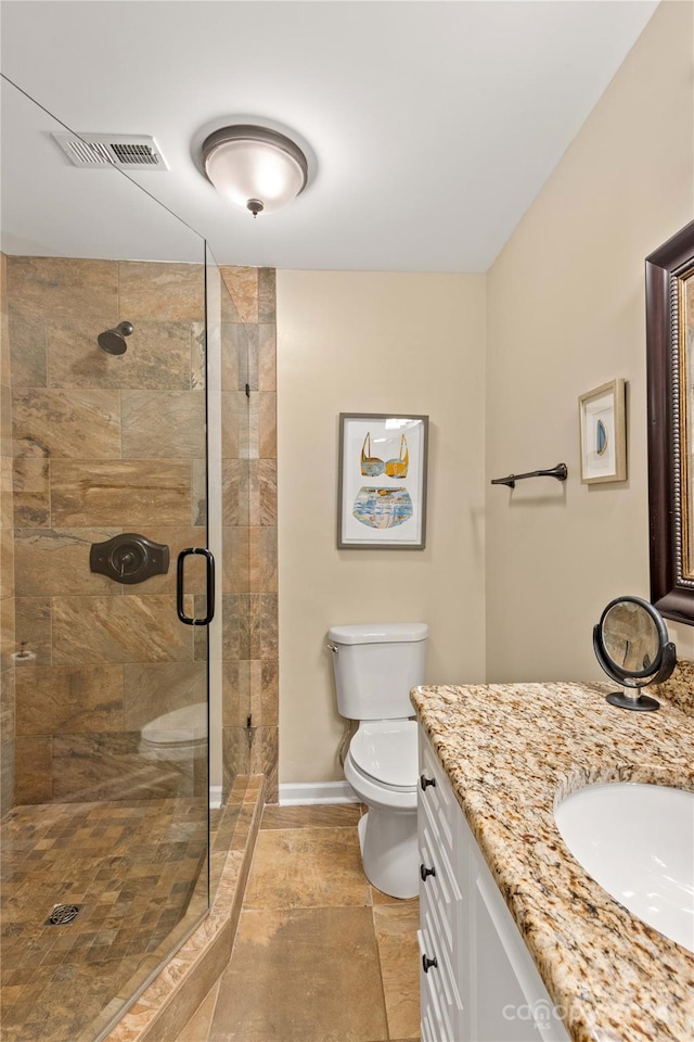 bathroom with tile patterned flooring, vanity, toilet, and an enclosed shower