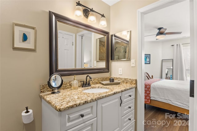 bathroom featuring hardwood / wood-style floors, vanity, and ceiling fan