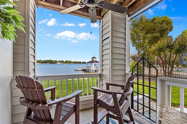 balcony featuring ceiling fan and a water view