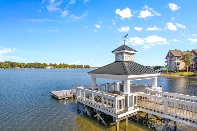 view of dock featuring a gazebo and a water view