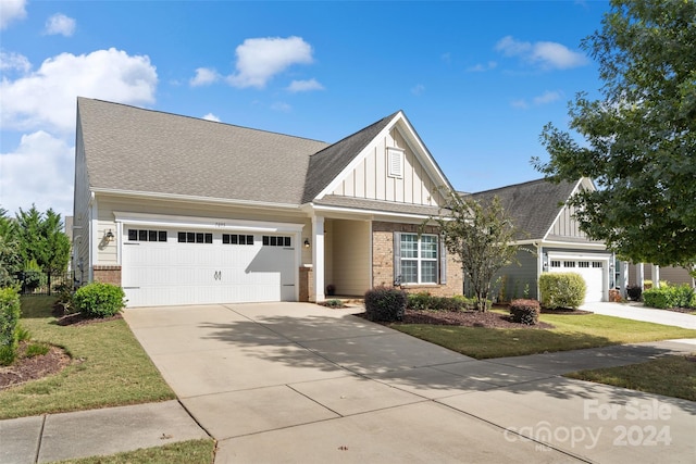 view of front of home featuring a front yard and a garage