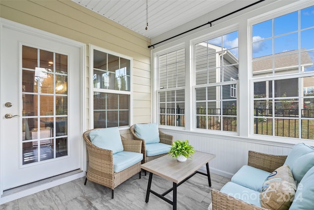 sunroom featuring a wealth of natural light and wood ceiling