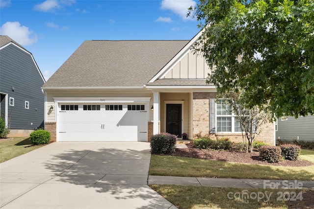 craftsman-style house with a front yard and a garage