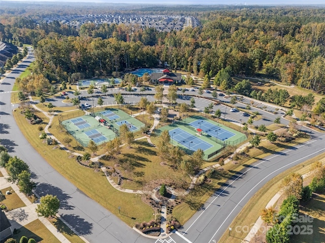 birds eye view of property featuring a wooded view