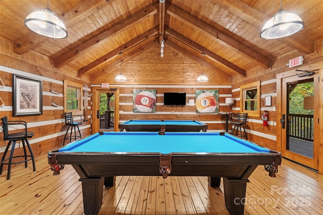 recreation room featuring hardwood / wood-style floors, lofted ceiling with beams, and wood walls