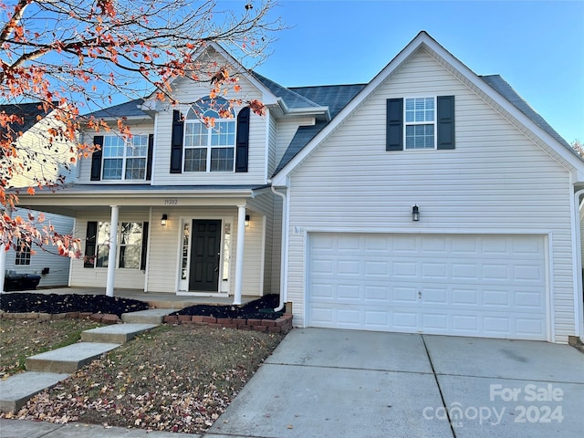 front facade featuring a porch and a garage