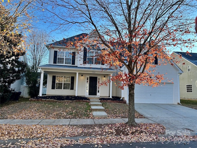 front of property with covered porch and a garage