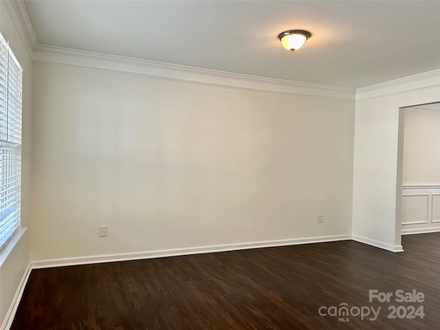 unfurnished room with dark hardwood / wood-style flooring, a healthy amount of sunlight, and ornamental molding