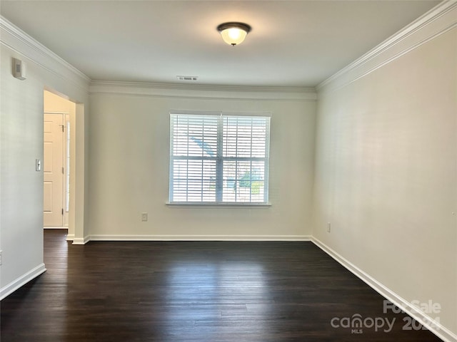 spare room with dark hardwood / wood-style flooring and ornamental molding