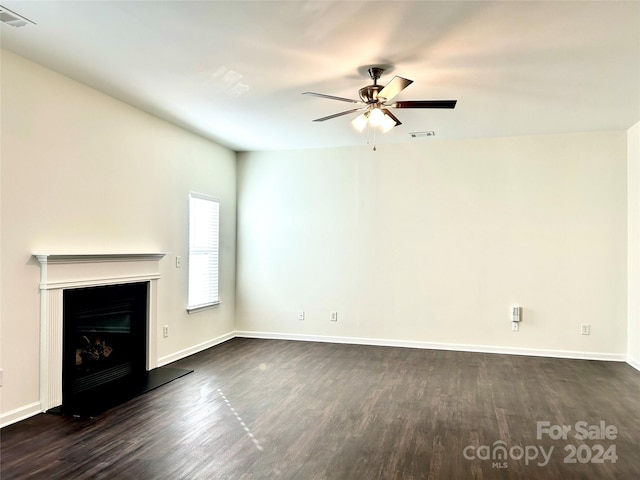 unfurnished living room featuring dark hardwood / wood-style floors and ceiling fan