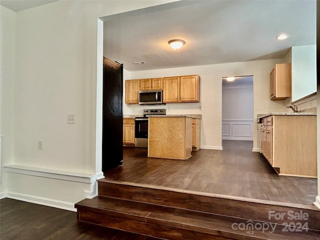 kitchen featuring light brown cabinets, dark hardwood / wood-style floors, and appliances with stainless steel finishes