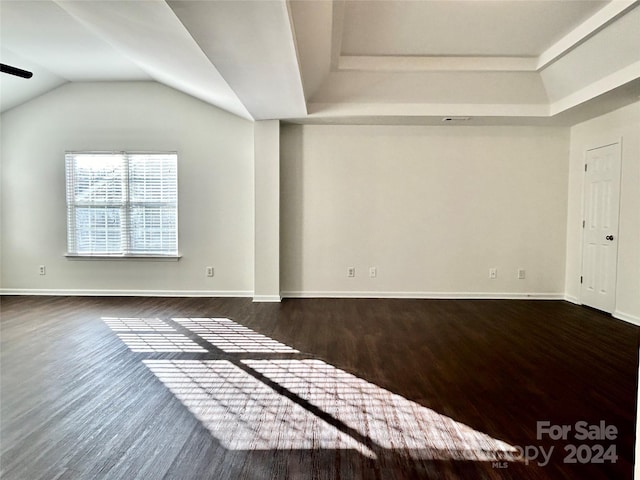 unfurnished living room with ceiling fan, dark hardwood / wood-style flooring, and vaulted ceiling