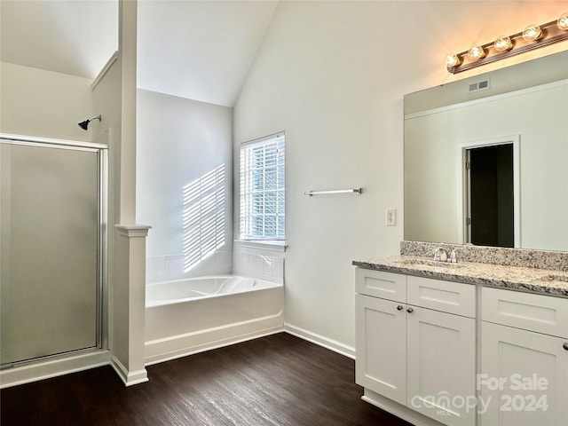 bathroom featuring wood-type flooring, vanity, independent shower and bath, and lofted ceiling