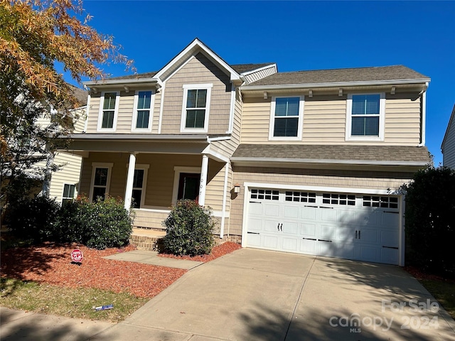 view of front of property with covered porch and a garage