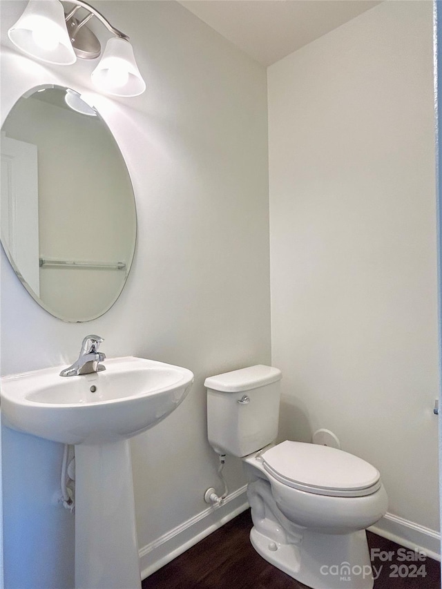 bathroom featuring sink, wood-type flooring, and toilet