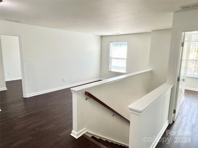 stairs featuring hardwood / wood-style floors