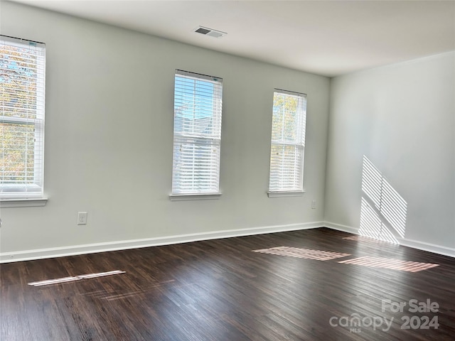 unfurnished room featuring dark hardwood / wood-style flooring