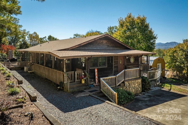 view of front of property featuring covered porch and a mountain view