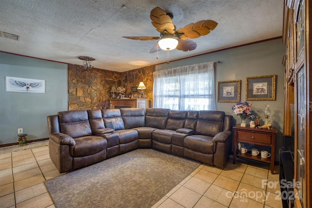 tiled living room featuring ceiling fan, a textured ceiling, and ornamental molding