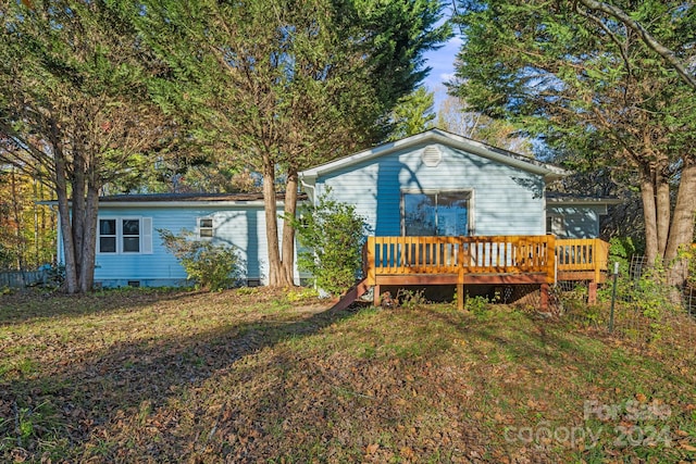 rear view of property with a wooden deck