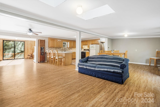 bedroom with light hardwood / wood-style flooring, ornamental molding, sink, white fridge, and ceiling fan