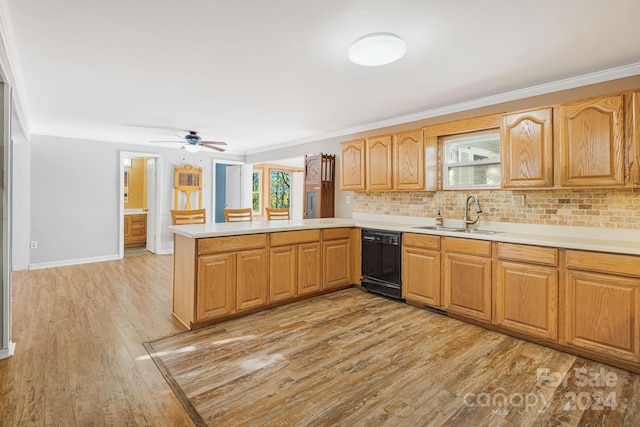 kitchen featuring kitchen peninsula, black dishwasher, ornamental molding, light hardwood / wood-style floors, and sink