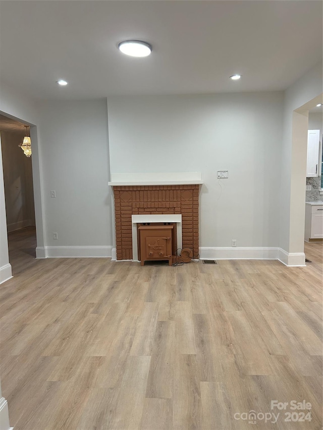 124 Elam St, Lawndale, NC 28090 - unfurnished living room featuring a brick fireplace, recessed lighting, baseboards, and light wood finished floors