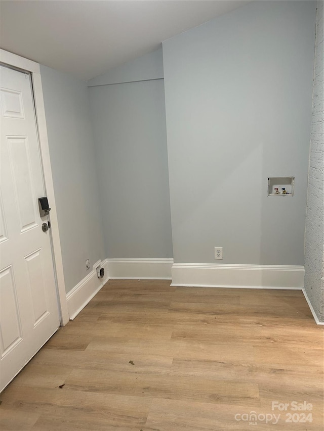 laundry room featuring washer hookup and light wood-type flooring