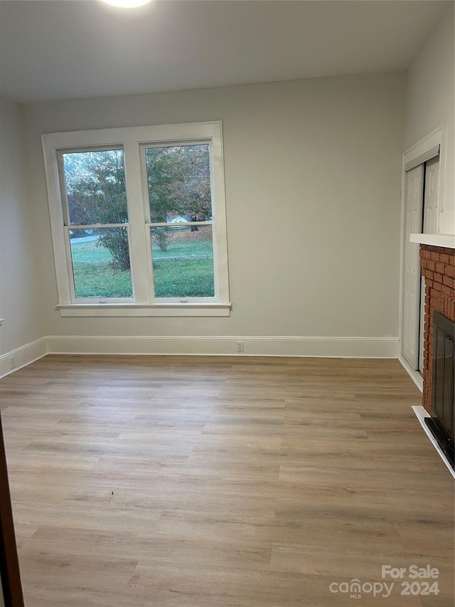 124 Elam St, Lawndale, NC 28090 - unfurnished living room with baseboards, light wood finished floors, and a fireplace