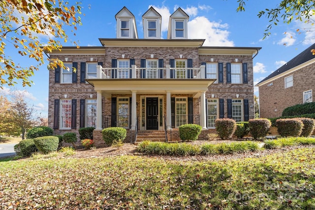 colonial home featuring a balcony