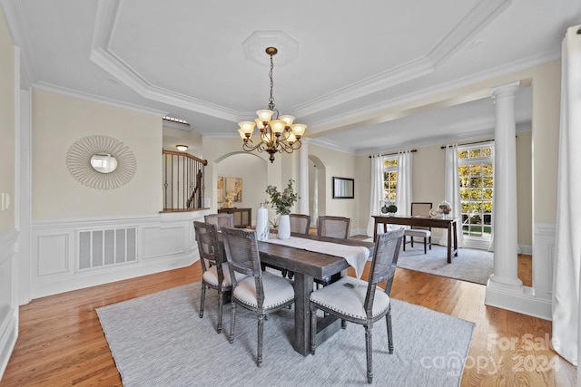 dining room featuring ornamental molding, a chandelier, and light hardwood / wood-style flooring