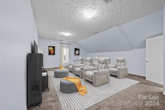 carpeted home theater with a textured ceiling and vaulted ceiling