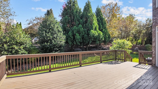 wooden deck featuring a yard