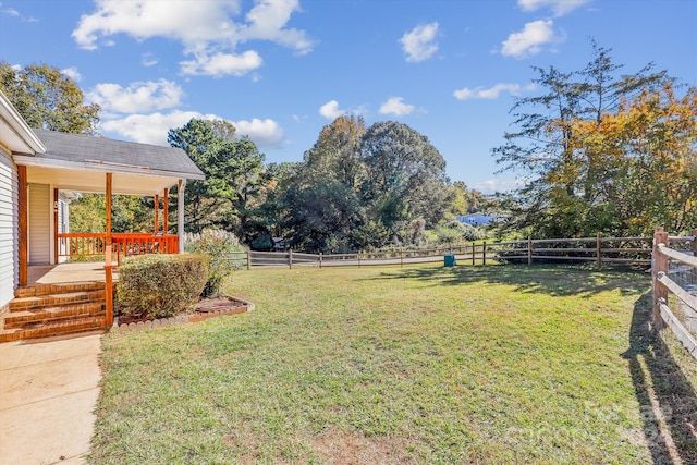 view of yard featuring a rural view and a deck