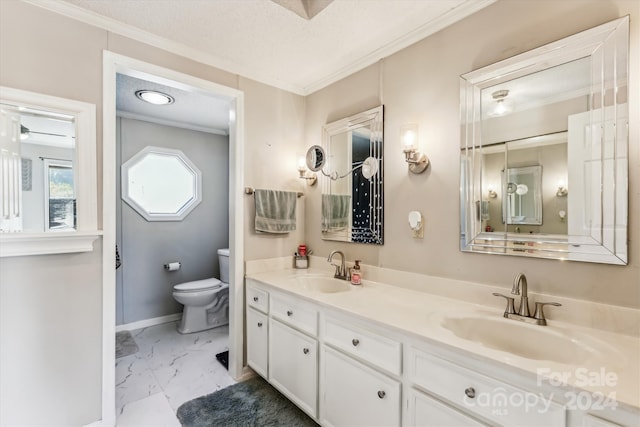 bathroom featuring vanity, toilet, ornamental molding, and a textured ceiling