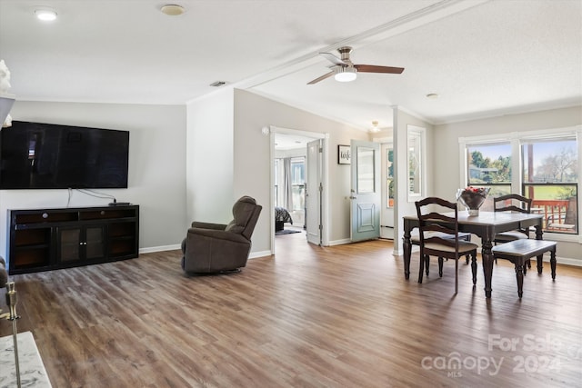 dining space with lofted ceiling, hardwood / wood-style floors, crown molding, and ceiling fan