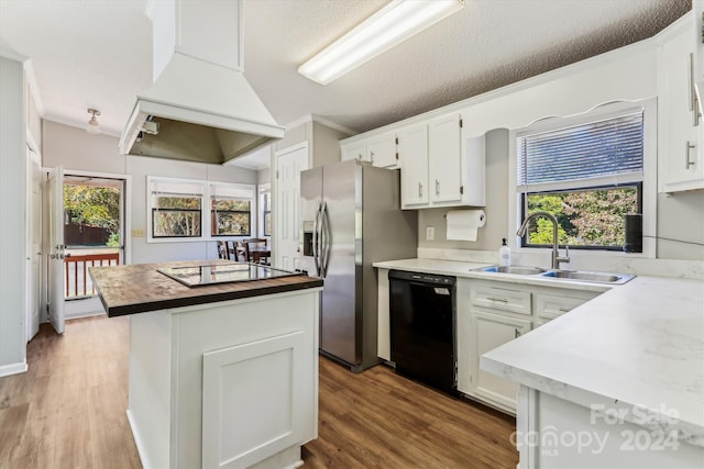 kitchen featuring white cabinets, black appliances, wood-type flooring, and a textured ceiling