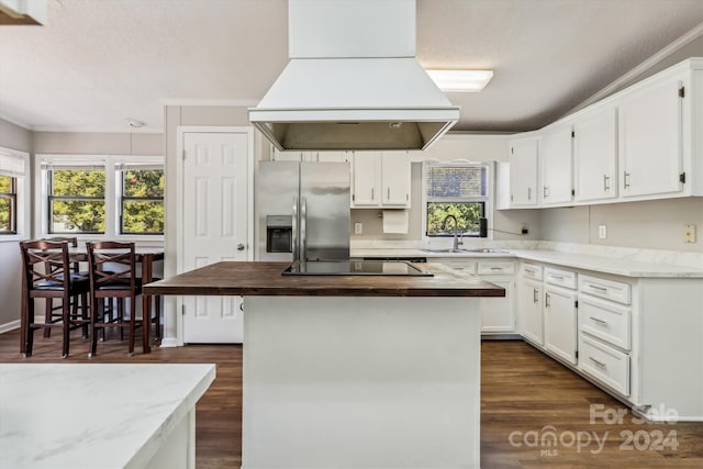 kitchen with island range hood, sink, stainless steel fridge with ice dispenser, and white cabinetry