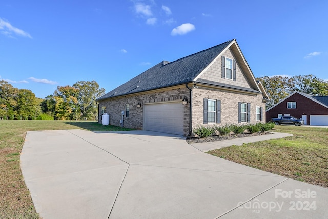 view of home's exterior with a garage and a lawn