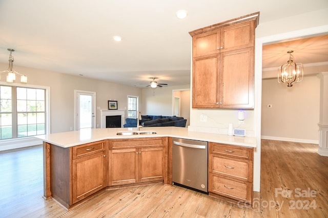 kitchen with sink, dishwasher, ceiling fan with notable chandelier, light hardwood / wood-style floors, and decorative light fixtures