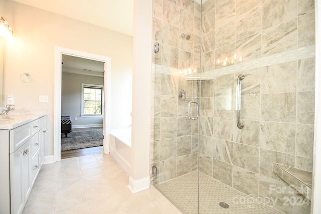 bathroom featuring vanity, independent shower and bath, and tile patterned floors