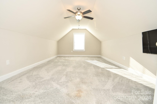 bonus room featuring ceiling fan, vaulted ceiling, and light colored carpet