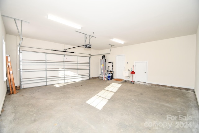 garage with a garage door opener and gas water heater