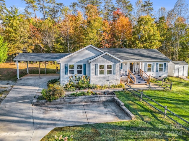 view of front of house with a storage shed and a front yard