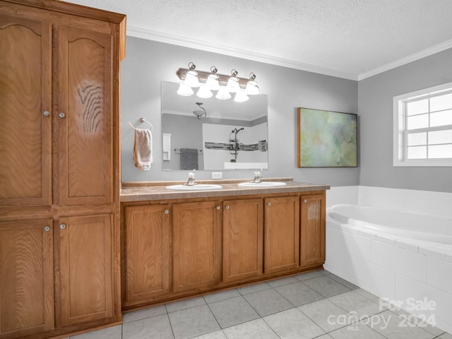 bathroom featuring a textured ceiling, vanity, crown molding, tile patterned floors, and tiled bath