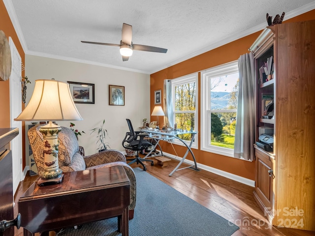 home office featuring crown molding, hardwood / wood-style flooring, a textured ceiling, and ceiling fan