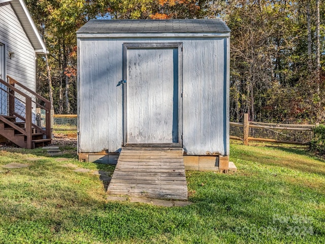 view of outdoor structure featuring a lawn