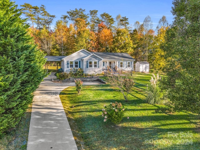 ranch-style house with a storage unit and a front lawn