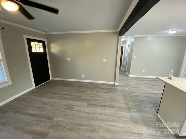 entrance foyer featuring ceiling fan, hardwood / wood-style flooring, and ornamental molding